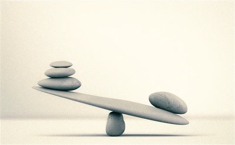 two balancing rocks on a beige background